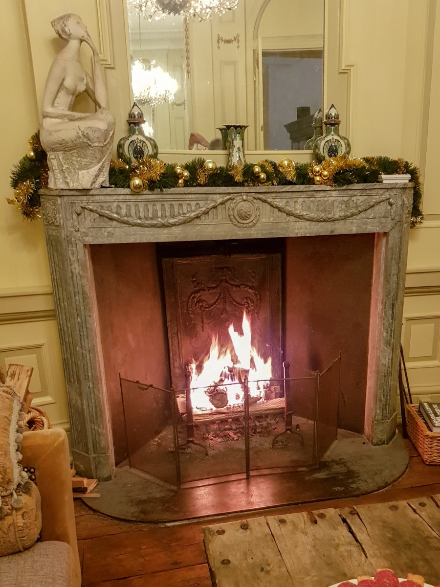 Pare feu de cheminée français ancien dans la cheminée ancienne avec la plaque de cheminée ancienne, les chenets anciens et la nouvelle grille de cheminée